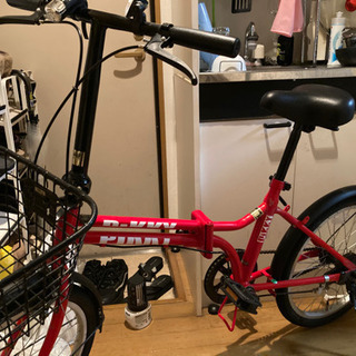 赤色の折りたたみ中古自転車の画像