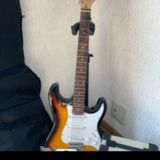 エレキギターと付属品一式の画像