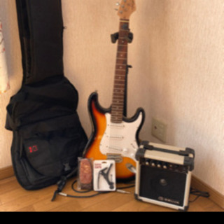 エレキギターと付属品一式の画像