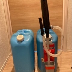 石油ファンヒーターとポリエチレン缶2個、電動ポンプの画像