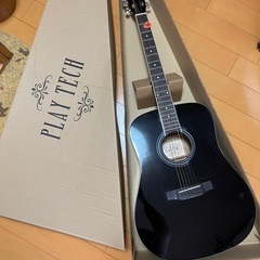 アコースティックギターとギタースタンドの画像
