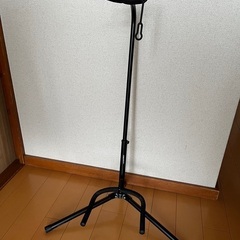 アコースティックギターとギタースタンドの画像