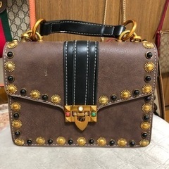 スタッズ　茶色　バッグの画像