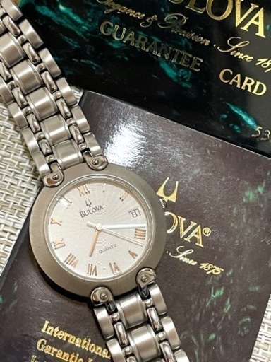 [ほぼ未使用美品:ギャランティ付属/稼働品]ブローバ BULOVA quartz デイト リストウォッチ/ラウンドフェイス/腕時計