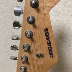 黄色のエレキギター　ギタースタンド付きの画像