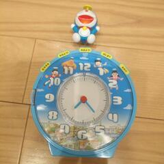 お札が吸い込まれる貯金箱＋喋るドラえもん目覚まし時計付きの画像