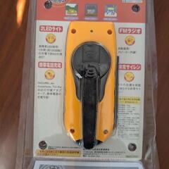 昔の携帯電話の充電器と手回しライトの画像