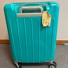 キャリーケース　青緑　ぼろぼろ
の画像
