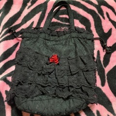黒いハンドバッグとポーチのセット。の画像