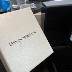 Emporio Armaniの空箱とハンドコマ（コマ調整用パーツ）付きの画像