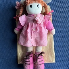 ピンクのリボン付き女の子　人形の画像