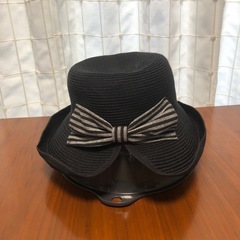 バックにリボンのある黒い帽子の画像