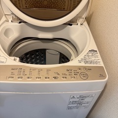 折り畳みベッド　と洗濯機
の画像