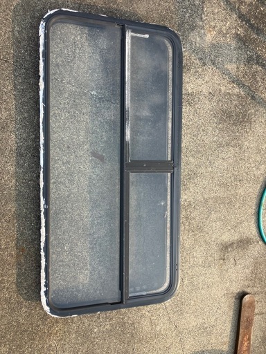 古いキャンピングトレーラーの窓　汚れ、キズあり