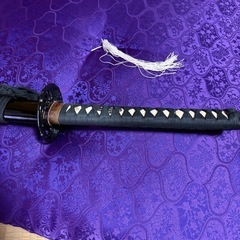 黒色の居合刀、鋼製刀身。の画像