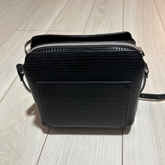 ③ストライプパターンの黒い合成皮革ショルダーバッグ、調整可能なストラップ付きのスクエアデザイン。 の画像