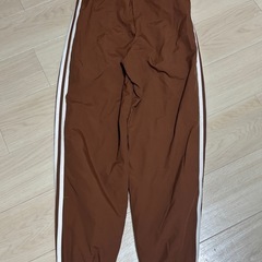 adidas ブラウン アディダス ウーブン ファイヤーバードトラックパンツの画像