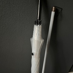 大きめのビニール傘とホウキの画像