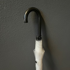 大きめのビニール傘とホウキの画像