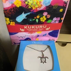 ウミガメのネックレスとハンカチの画像