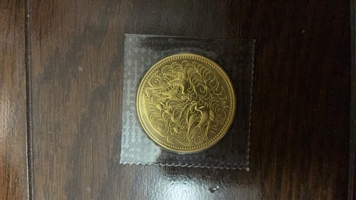 「天皇陛下御在位60年記念 10万円金貨」