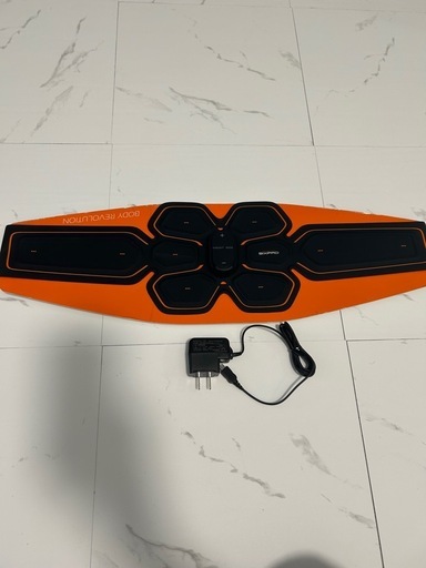 EMSトレーニングデバイス、オレンジ色、充電器付き。
