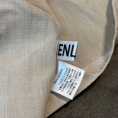 ENLIKE トップス オフホワイトの画像